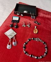 Full layout of all jewelry pieces on red surface