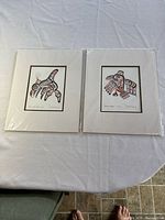 Both matted Bill Reid prints side by side