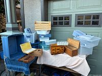 overall view showing variety of plastic bins, crates and wooden storage pieces