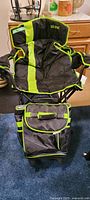 Photo showing the Uline camping chair with neon green stripes and the matching cooler bag, both in excellent condition.