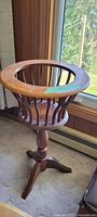 Maple wood plant stand showing basket-style vertical slats and circular top with maple trim.