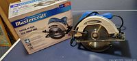 Mastercraft circular saw displayed next to its original box showing brand and model details.