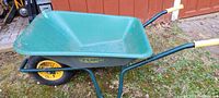 Side and top view of the green Tuff wheelbarrow showing plastic tray and yellow wheel.