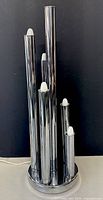 Full photo of chrome cylindrical 6-light table lamp with all lights off.