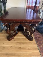 Overall front view showing rectangular top, carved apron and dragon leg supports