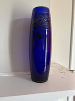 Full view of tall cobalt blue vase with silver decorative band