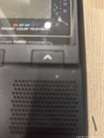 Close-up side view showing speaker grill and part of tuning button.