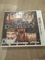 Front cover of Duck Dynasty video game for Nintendo 3DS showing cartoon characters of the Robertson family and game title.