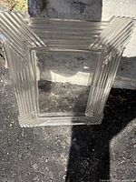 Top angled view of clear crystal photo frame with geometric Art Deco ridged design