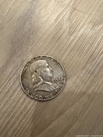 Obverse side showing Benjamin Franklin profile, the date 1954 and 'LIBERTY', 'IN GOD WE TRUST' inscriptions.