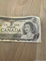 Front side of the 1973 Canadian $1 banknote showing Queen Elizabeth II and serial number BFJ1900176.