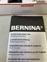 Black and white operating instructions booklet for Bernina Eyelet Embroidery Set with multilingual text.