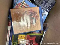 Photo showing a box with multiple DVDs and CDs, prominently featuring The Last Waltz DVD on top.