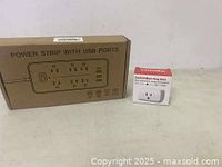 Photo showing the box of a power strip with USB ports alongside the box of a SwitchBot Plug Mini smart plug.