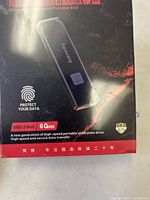 Close-up of the front of the product box showing a digital image of the SSD, fingerprint lock icon, USB specifications, and 6Gbps speed indication.