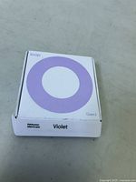 Closed box of Loop Quiet 2 earplugs in violet color showing front packaging with brand, model and color.