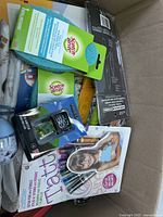 Top view of box showing Scotch-Brite sponges, Minecraft collectible, kids nail polish kit, and other items.
