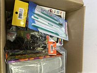 Box with four-pack dental hygiene kit, Halloween pencils, and assorted packets