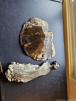 Top view of both handcrafted pottery wall art pieces showing texture and color variations