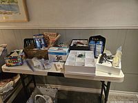 Overview of the entire jewelry craft kit displayed on a table including boxes, tools, and storage containers.