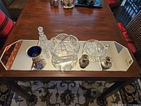 Overview of 10 pieces arranged on Deco mirrored tray showing table top pieces in crystal and silver plate.