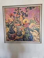 Framed floral print by Jae Dougall shown hung on wall, capturing colors and frame detail.