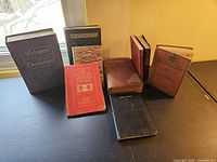 Collection of 9 English classic books displayed on a table in natural light