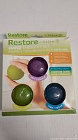 Front of box showing the three textured therapy balls for soft, medium, and firm resistance levels.