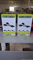 Two boxed SoleSkate units displayed side by side on a table in a store environment, showing front packaging with product name and image.