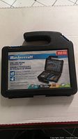 Front of black hard plastic carrying case with Mastercraft label showing 253 piece set image and basic features