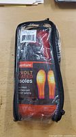 Front view of the packaged Venture 12 Volt Heated Insoles showing brand, product type, size, and key features.