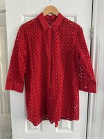 Front view of red Foxcroft women's cotton shirt with eyelet design on hanger