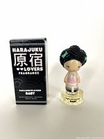 Harajuku Lovers Baby perfume bottle with original black box packaging. The doll figure cap is on the bottle.