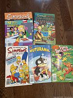 Photo showing front covers of 5 comic books fanned out on floor