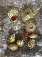 Photo of nine assorted antique mercury glass Christmas bulbs in bubble wrap packaging.