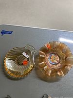 Top view of the ombre seashell and candy dishes placed on a gray surface.