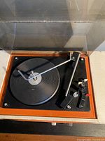 Top-down view of the record player showing the black platter and tonearm.