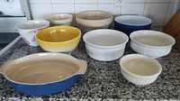 All nine bowls and dishes arranged on countertop