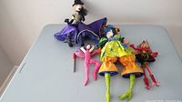 All four fabric dolls arranged on table