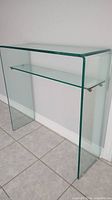 Front view of bent glass console table and shelf