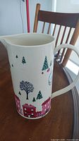Full view of Kate Spade Arbor Village pitcher side with house and tree graphics