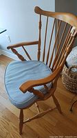 Front view of maple spindle-back armchair with cushion