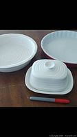 Top view of flan dish, pie dish, butter dish with lid