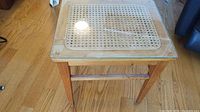 Full view wooden low table with glass top and cane insert