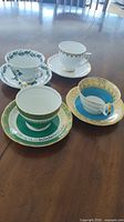 All four teacup and saucer sets on table