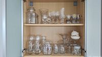 Cabinet view showing all listed glass items on two shelves