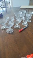 Group of eight Cornflower etched stem glasses on table