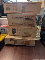 Stack of 4 vintage Lionel train boxes showing printed labels and vintage design.