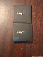 Top view of two closed Cargo HD Highlighter boxes on a wooden surface