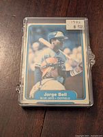 Front of the George Bell 1982 Fleer rookie card showing him in Toronto Blue Jays uniform, with a price sticker of $5.00 attached to the outer plastic case.